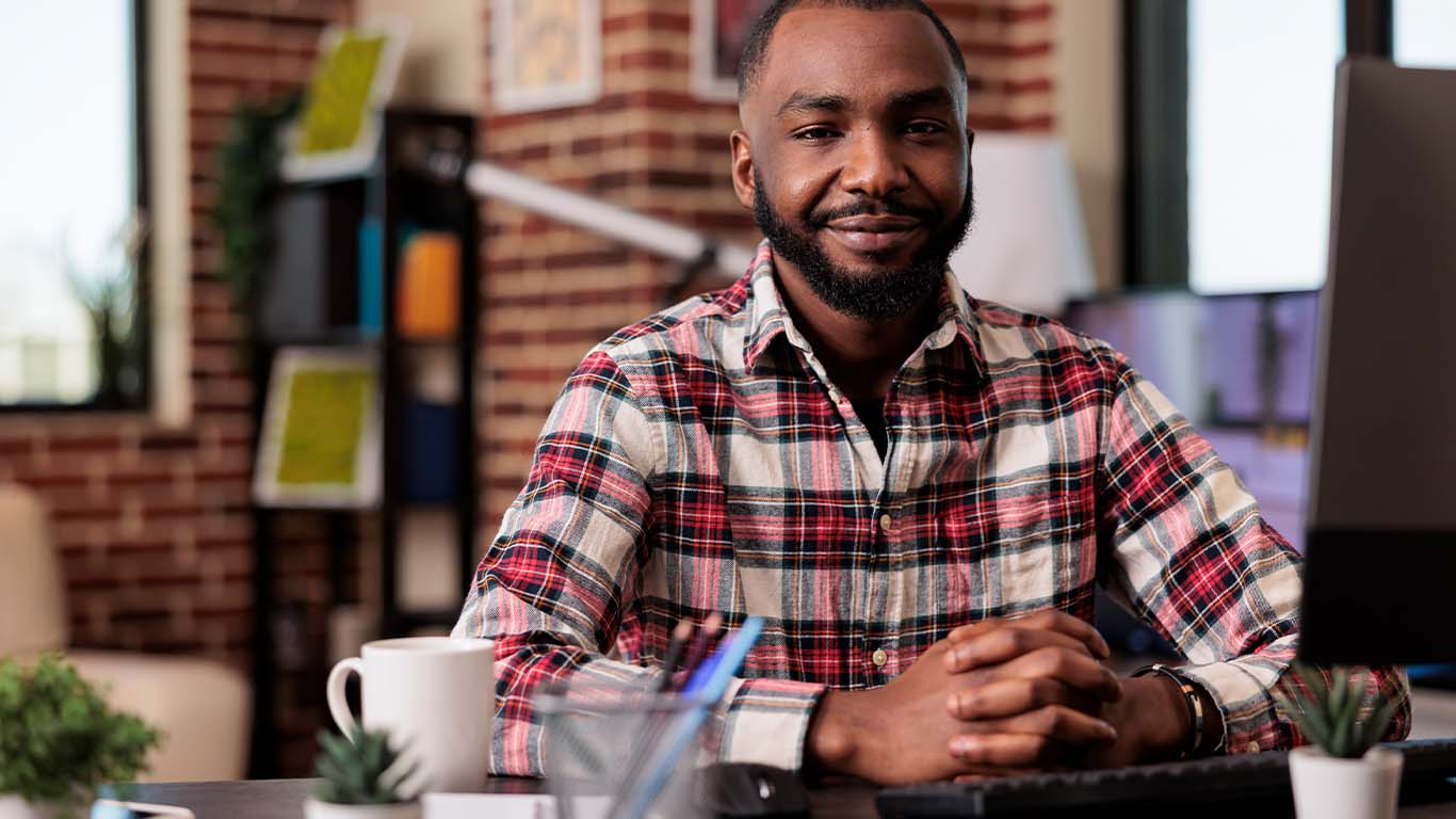 AFRICAN MAN COMPUTER SMILING